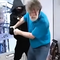 An elderly man wrestles with an armed robber in a store