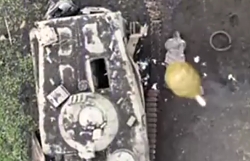 Solider lying next to Destroyed BMP is hit by F1 grenade