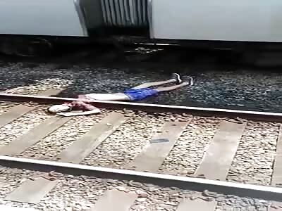 Man takes off on the train tracks