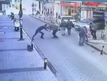 Dude Crossing the Street is met by an Assassin Who Only Manages to Shoot Him in the Leg