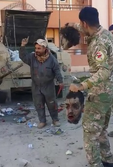 Solider Dancing with Joy with Two Daesh Members Heads