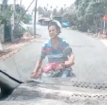 Moped Rider Takes the Turn Too Wide.