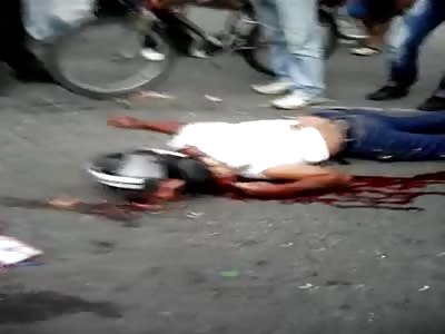 Motorcyclist dies head crushed by a truck