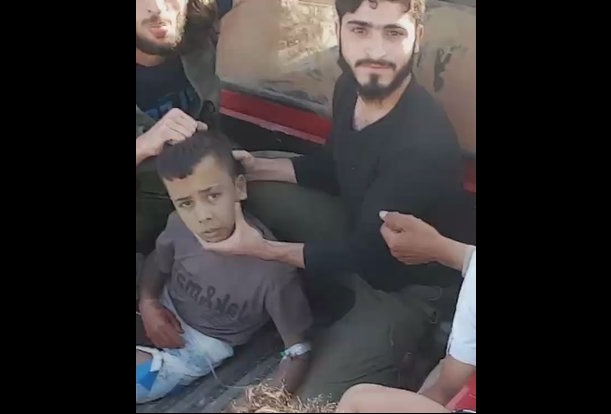 *Uncensored* Shock Video Shows 12 Years Old Boy Being Beheaded by Syrian Rebels