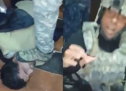 Soldier cuts Off  Young Man's Ear and shows it to the Camera