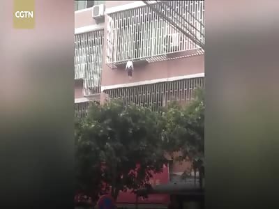 Girl dangles from third floor apartment