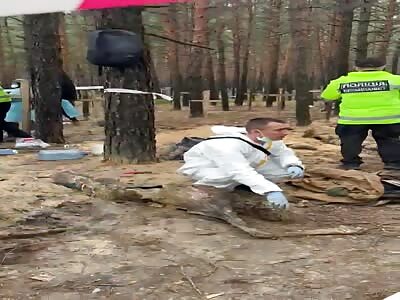 Ukraine began exhuming more than 440bodies found in a mass burial site
