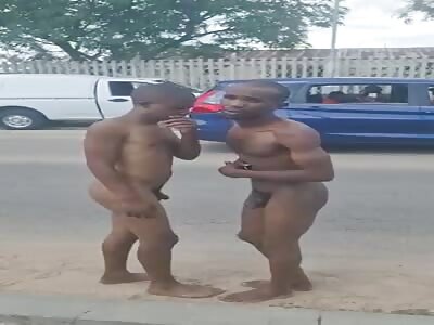 Two thieves humiliated and forced to kiss each other in middle of stre