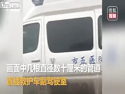 Ambulance gets penetrated by long pipes