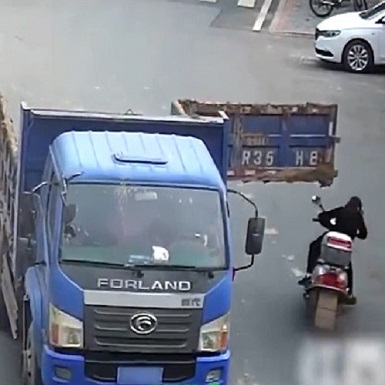 Back Door Opens on a Truck and Sends Motorcyclist to the Underworld 