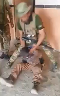 Another terrorist captured and beaten by Iraqi troops...