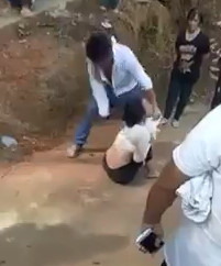 Angry jealous husband punishes his wife in front of the villagers