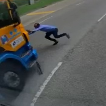 Man Tries to Stop Truck Unsuccessfully