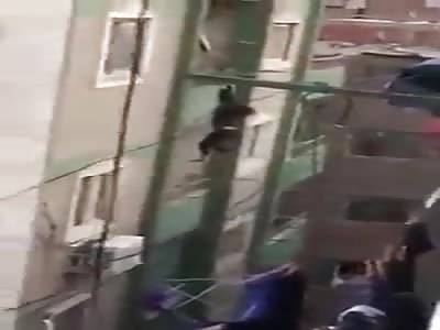 woman hanging from 7th floor balcony..falls