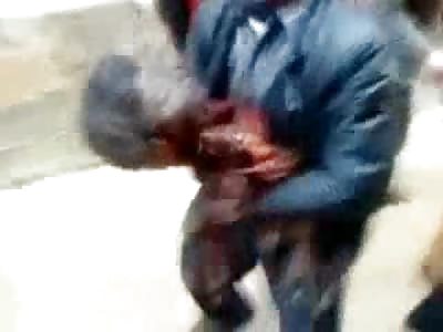 Shocking Video shows a Father carrying the HEAD of his Murdered Son down the Street...